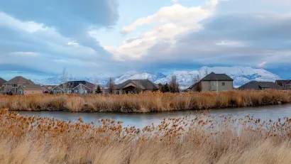 Homes in Saratoga Springs, Utah with pond in foreground.