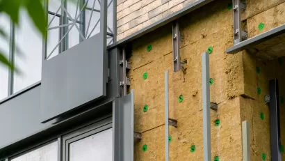 Installation of external wall thermal insulation with rock wool on Passive House residential building.