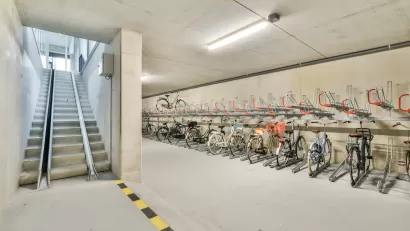 Bike parking in underground area with ramp for taking bikes upstairs.
