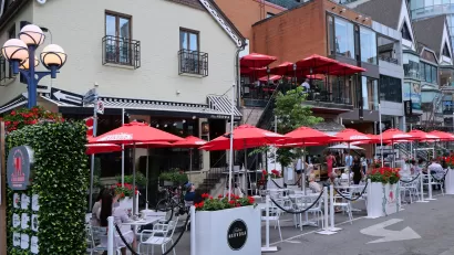 Outdoor dining patio with red umbrellas in Toronto, Canada