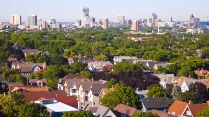 Milwaukee, Wisconsin skyline with houses in foreground.