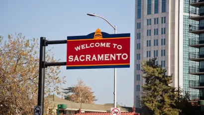 Red 'Welcome to Sacramento' sign in downtown Sacramento, California.