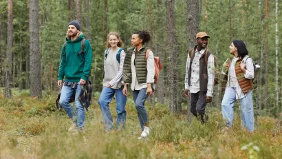 Diverse group of young people walking through forest