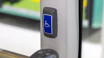 Close-up of accessible stop button on public bus.