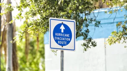 Blue and white "hurricane evacuation route" sign.