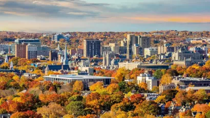 New Haven, Connecticut downtown skyline with fall foliage in foreground.