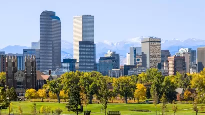 Denver, Colorado skyline with green lawn in the foreground.