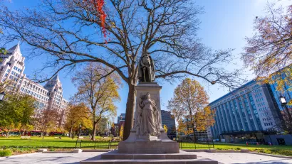 Statue in Franklin Square Park in Washington, D.C. with dry fall tree in background