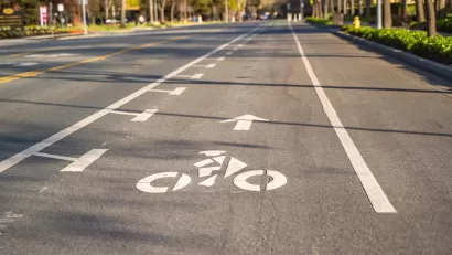 Bike lane marked with white paint on asphalt street.