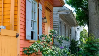 Close-up angled view of colorful wood clapboard small historic homes with chipping paint in New Orleans, Louisiana.