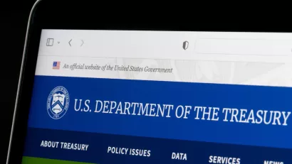 Close-up of laptop screen with U.S. Treasury Dept. website pulled up.