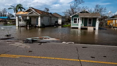 Two small wood homes with floodwaters in coastal Louisiana after Hurricane Ida.
