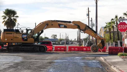 Yellow Cat heavy equipment working on light rail construction on road in Phoenix, Arizona.