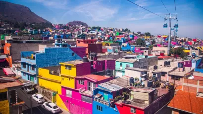 View of colorful dense buildings in Mexico City from aerial cable car.