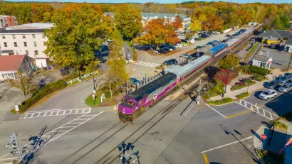 Aerial view of purple MBTA train at West Concord station in Concord, Massachusetts.