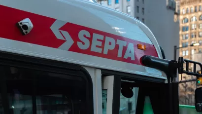 Close-up of SEPTA logo in white letters on red line at top of SEPTA bus in Philadelphia, Pennsylvania.