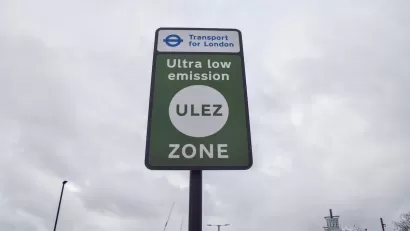 Close-up of green "Ultra low emission zone" ULEZ sign in London, UK.