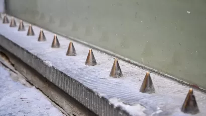 Spikes on building designed to prevent people from sitting.
