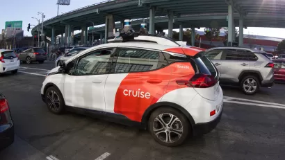 White and red Cruise self-driving vehicle on a San Francisco street.