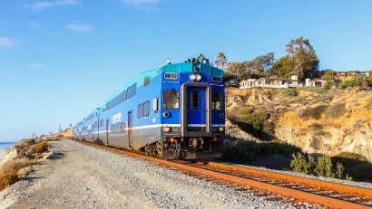 Blue train on coastal rail in Southern California.