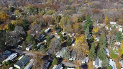 Aerial view of mobile home park with mature trees in Rochester, New York.