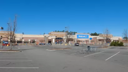 Large Walmart store with empty parking lot.