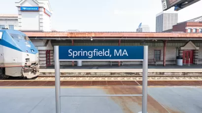 Springfield, MA outdoor Amtrak station platform with train pulling in.
