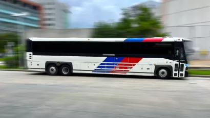 Houston Metro bus moving rapidly across blurred background.