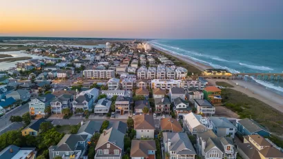 Aerial view of dense neighborhood with beach homes on coast in Wrightsville Beach, North Carolina.