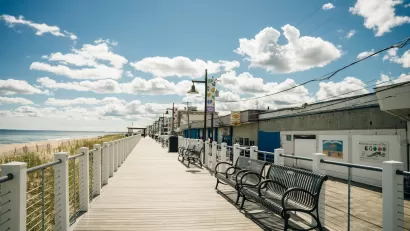 Wooden beachside boardwalk with benches in Salisbury, Massachusetts.