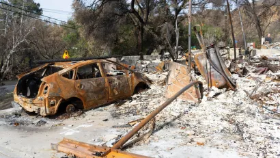Burned car and home in Los Angeles after 2019 wildfire.