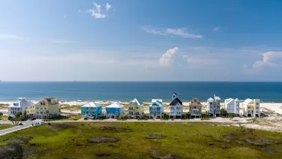 Row of colorful two-story beach homes on Gulf Coast beach in Alabama.