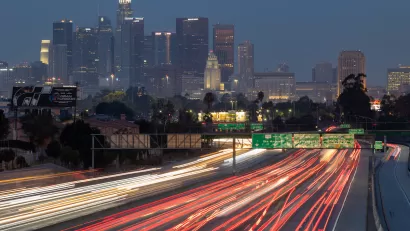 Early morning view of downtown Los Angeles with blurred heavy traffic on Interstate 10 in foreground.