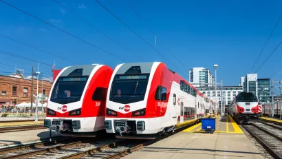 Two red and white electric trains, part of Caltrain fleet in San Francisco, California.