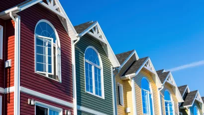 Close-up of row of colorful townhouses with triangular roofs