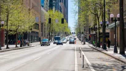 Street view of 4th Avenue, a commercial street of shops and restaurants through the city center of downtown Seattle, Washington.