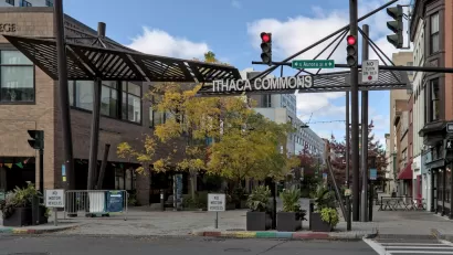 View of Ithaca Commons sign over pedestrian street in downtown Ithaca, New York.