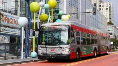 Muni bus on red painted bus-only lane in downtown San Francisco, California.
