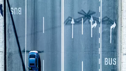 Bird's eye view of multi-lane road with dedicated bus lanes.