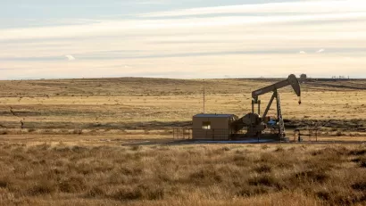 Oil well in prairie landscape.