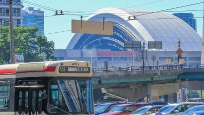 Vintage red Toronto streetcar passing in front of Rogers Arena in Toronto, Canada.