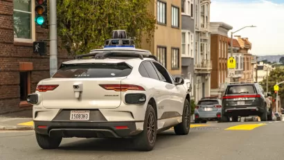 White Waymo self-driving car on street in San Francisco, California.