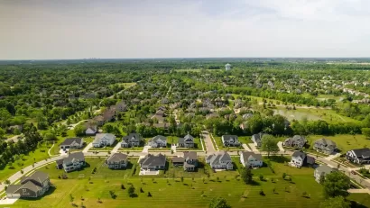 Aerial view of suburban neighborhood with large houses and green grass near Columbus, Ohio.