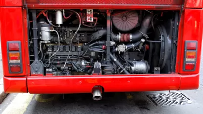 A view of the mechanics of the engine at the back of a public bus.