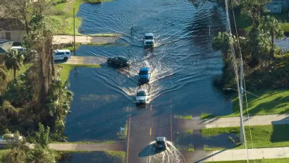 Aerial view of cars evacuating flooded residential neighborhood in Florida.