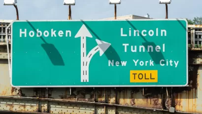 Close-up of green and white sign for Lincoln Tunnel and Hoboken.