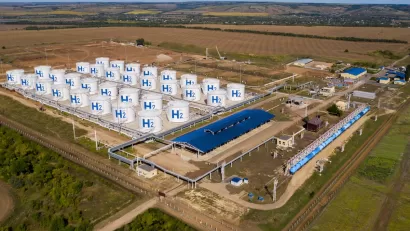 Aerial view of hydrogen storage hub in green field.