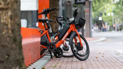 Orange Biketown bike share bikes parked at station on sidewalk in Portland, Oregon,