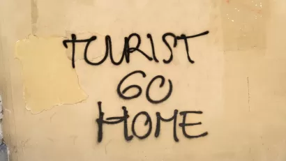 "Tourist go home" graffiti on a wall in Barcelona, Spain.