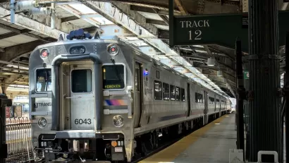 New Jersey Transit passenger rail commuter train at station in Hoboken, New Jersey with platform 12 sign.